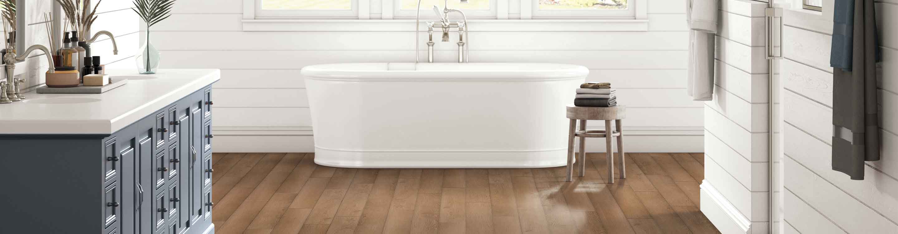 waterproof wood look flooring in bathroom with white tub